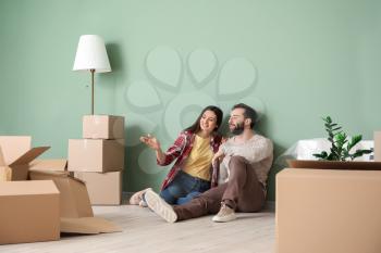 Happy young couple with cardboard boxes in their new house�