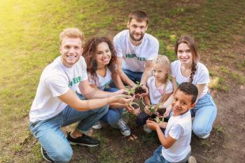 Volunteers with young plants outdoors�