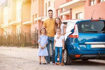 Happy family near car outdoors�