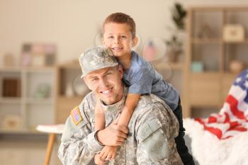 Happy military man with his son at home�