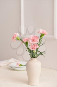 Beautiful carnation flowers in vase on table�