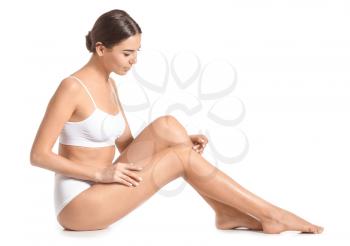 Woman with beautiful legs after depilation on white background�