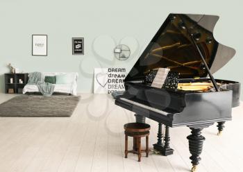 Stylish grand piano in light room�