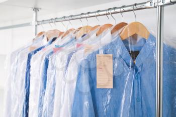 Rack with clothes in modern dry-cleaner's�