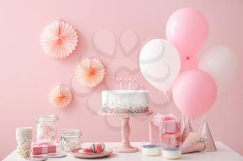 Tasty candy bar for Birthday party on table against color background�