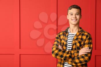 Cool teenage boy on color background�