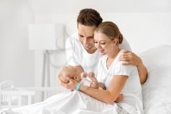 Young family with newborn baby in maternity hospital�