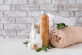 Cosmetics with towels on white table�