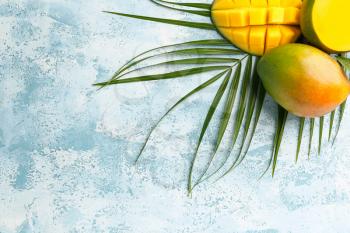 Tasty mango fruit on color background�