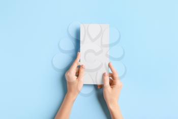 Female hands with blank menu on color background�