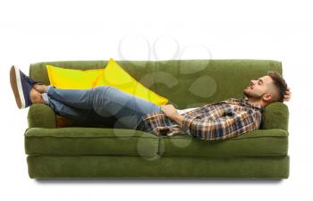 Young man relaxing on sofa against white background�
