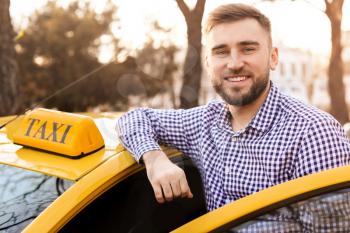 Portrait of handsome taxi driver outdoors�