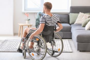 Young man in wheelchair at home�