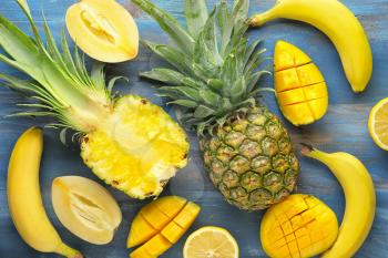 Summer composition with tropical fruits on wooden background�