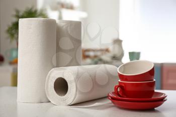 Rolls of paper towels with dishware on kitchen table�