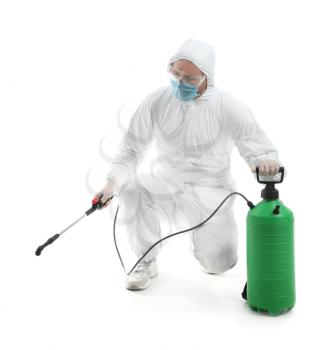 Worker in biohazard suit and with disinfectant on white background�