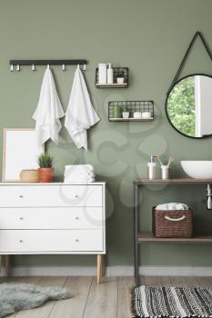 Modern interior of stylish bathroom with towels on hooks�