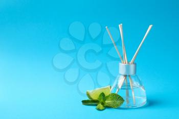 Reed diffuser with lime and mint on color background�