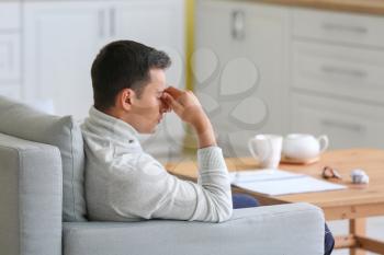 Stressed young man at home�