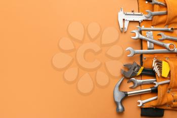 Set of construction tools on color background�