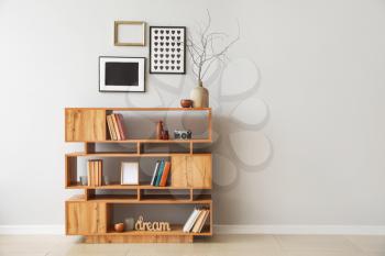 Shelving unit with books and decor in interior of room�