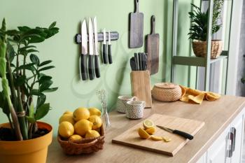 Set of knives and lemons on counter in kitchen�