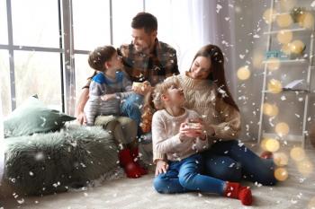 Happy family resting at home on Christmas eve�