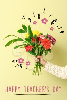 Female hand with beautiful bouquet of flowers and text HAPPY TEACHER'S DAY on color background�