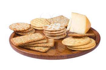 some crackers on the wooden plate isolated on white background 