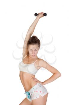 attractive young girl is doing some exercises with dumbbell.Isolated on white