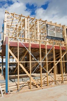 New residential construction home wooden framing against a blue sky