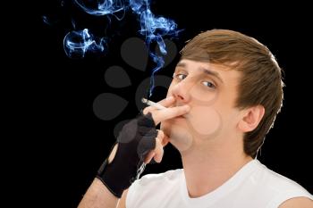 Royalty Free Photo of a Young Man Smoking a Cigarette