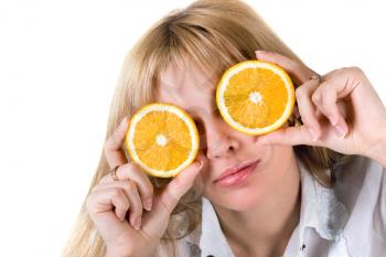 Royalty Free Photo of a Woman With Orange Slices Over Her Eyes