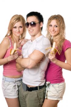 Royalty Free Photo of a Boy With Two Girls Eating Bananas