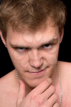 Closeup portrait of a spiteful young man. Isolated