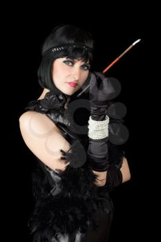 Portrait of brunette with a cigarette holder dressed in retro style