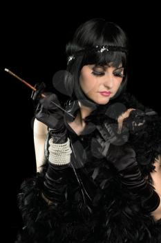Portrait of brunette with a cigarette holder dressed in retro style. Isolated