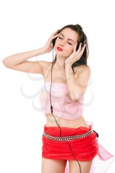 Sexy young woman listening to music with closed eyes. Isolated on white