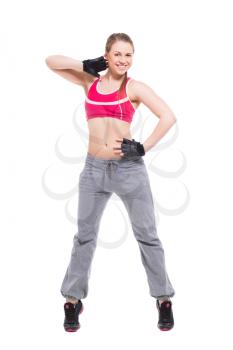 Cheerful young woman dancing in sport clothes. Isolated on white