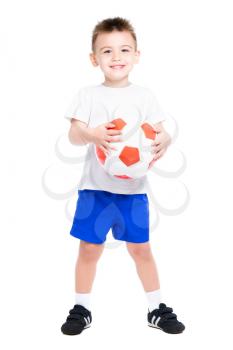 Cheerful nice boy posing with a soccer ball. Isolated on white