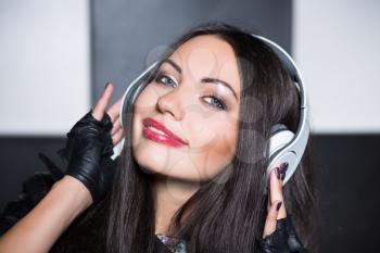 Portrait of pretty smiling brunette with headphones