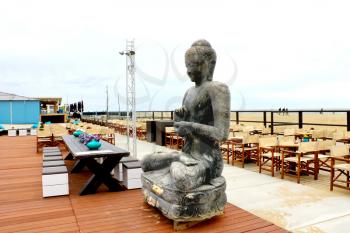 Spring on the coast. The statue in the outdoor cafe at The Hague. Netherlands. den Haag