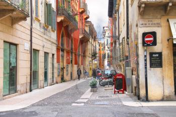 VERONA, ITALY - MAY 7, 2014: People on a narrow street in Verona, Italy 