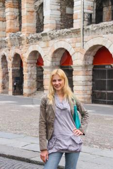 Attractive girl near the Arena of Verona - the place of annual festival operas in Verona, Italy