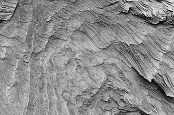 patterns of erosion of sand in the background