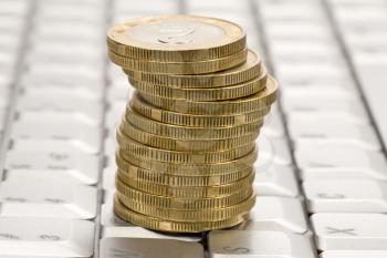 Royalty Free Photo of a Stack of Coins on a Computer