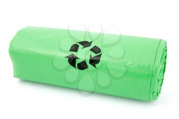 Green garbage bio bags in a roll on white background