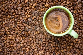 Image of coffee beans and green cup 