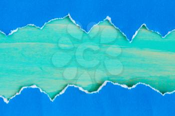 Torn  paper with a blue wooden background for your text