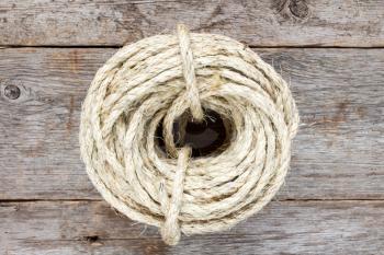  Roll of sisal rope on the old wooden surface